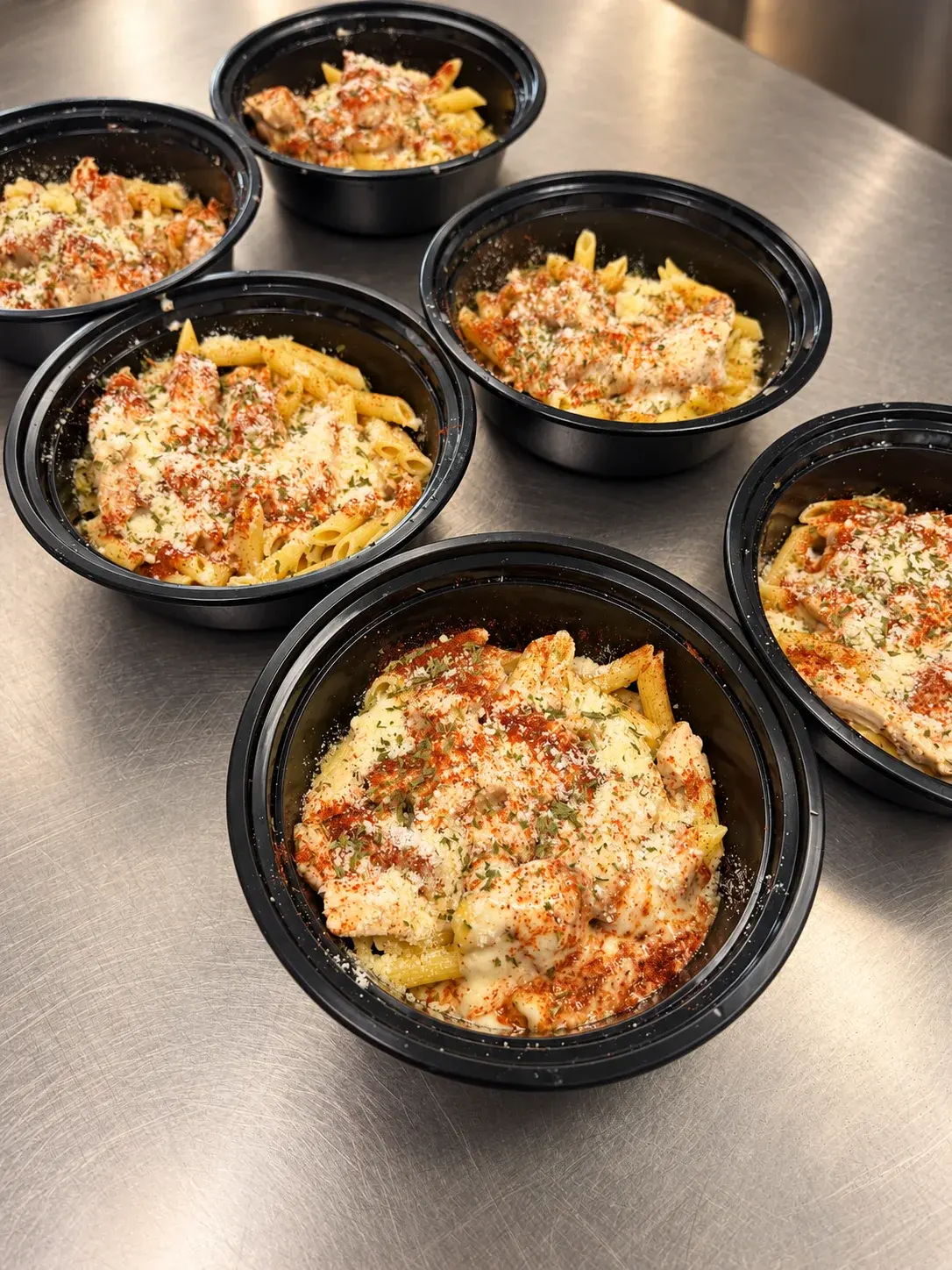 Chicken penne pasta with creamy sauce and grated cheese