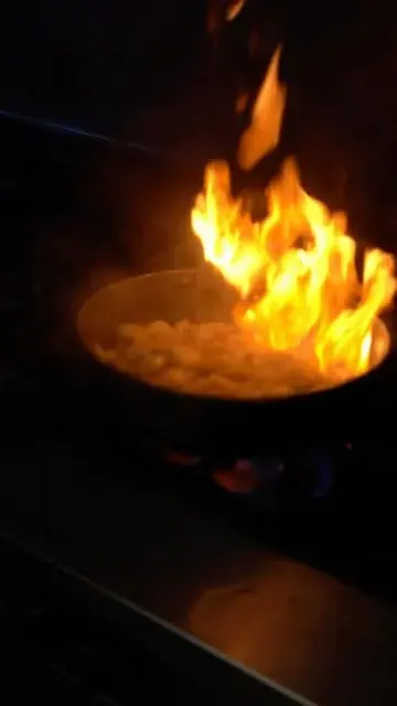 Flames rising from a pan on the Breaking the Fast kitchen stove